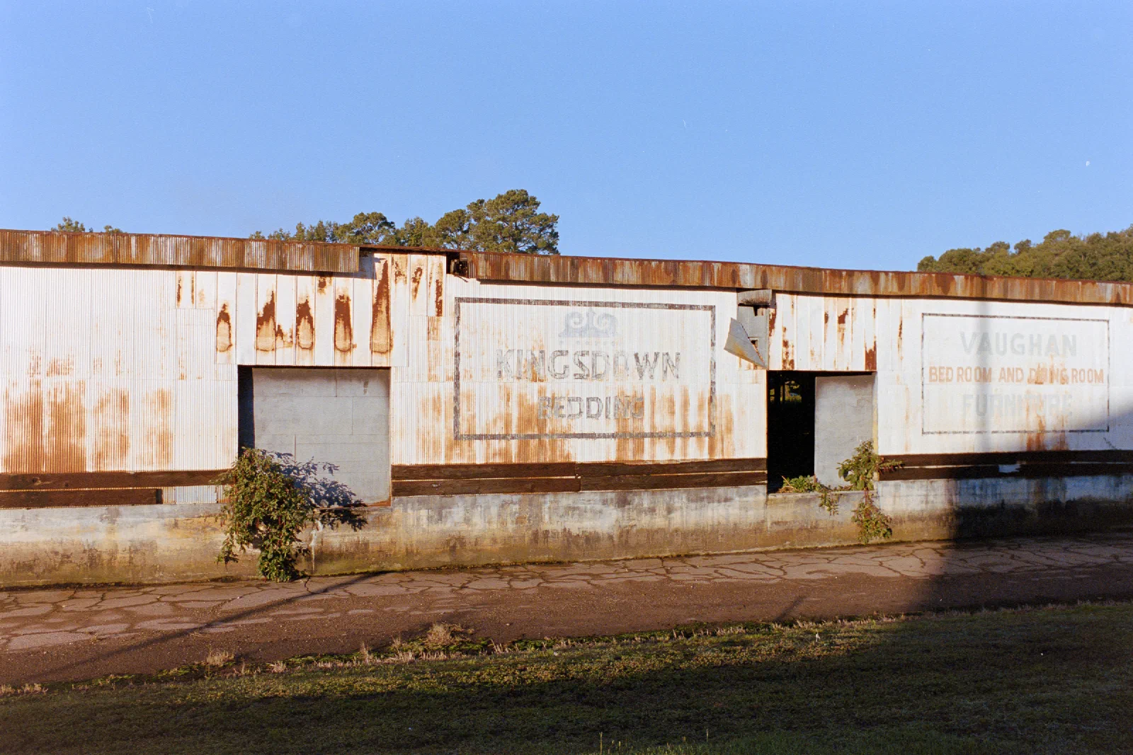Rust-stained abandoned warehouse with faded painted signs