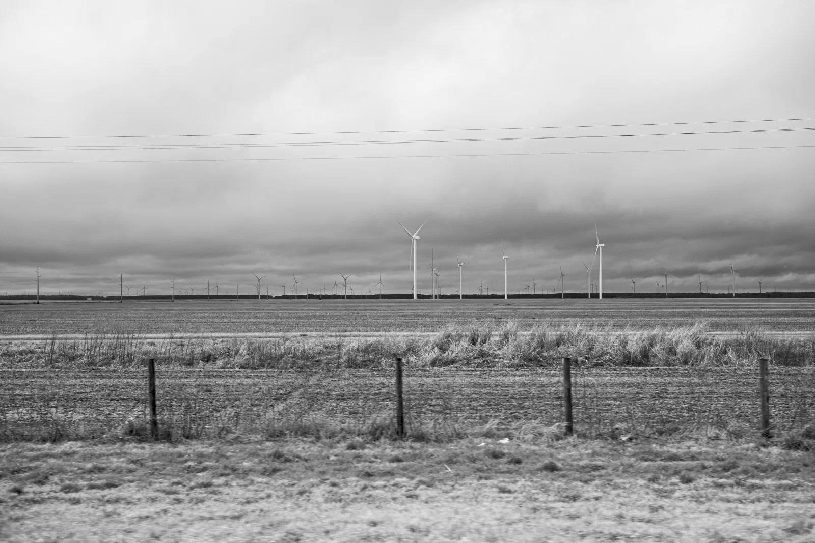 Black and white landscape of wind turbines under low clouds near Elizabeth City